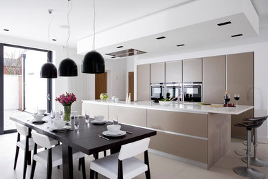 Photo of a medium sized contemporary single-wall kitchen/diner in Other with a submerged sink, flat-panel cabinets, an island and grey floors.