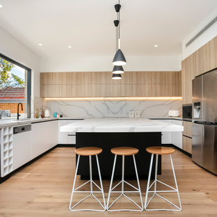 Inspiration for a mid-sized contemporary u-shaped kitchen in Sydney with an undermount sink, light wood cabinets, marble benchtops, stone slab splashback, stainless steel appliances, medium hardwood floors and with island.