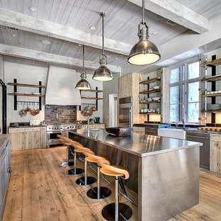 Contemporary enclosed kitchen appliance - Example of a trendy enclosed kitchen design in Houston with stainless steel appliances, a farmhouse sink, flat-panel cabinets, medium tone wood cabinets and stainless steel countertops