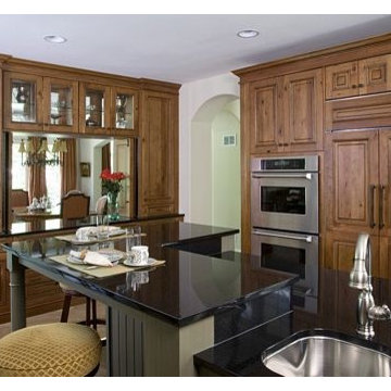 Knotty Cherry Raised Panel Perimeter Cabinetry with Painted Green Island