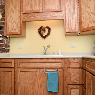 Inspiration for a mid-sized transitional u-shaped separate kitchen in Other with a drop-in sink, recessed-panel cabinets, light wood cabinets, laminate benchtops, white appliances, laminate floors, no island, brown floor and beige benchtop.
