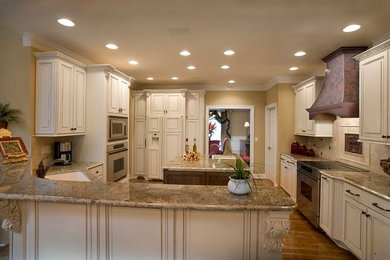 Inspiration for a transitional kitchen remodel in Other with raised-panel cabinets and an island
