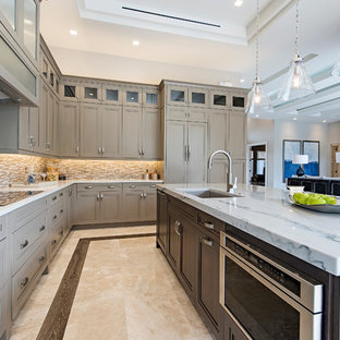 Design ideas for a mid-sized transitional l-shaped eat-in kitchen in Miami with an undermount sink, recessed-panel cabinets, quartzite benchtops, brown splashback, stone tile splashback, stainless steel appliances, marble floors and with island.