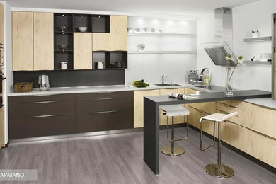 Medium sized contemporary u-shaped kitchen/diner in Other with flat-panel cabinets, light wood cabinets, quartz worktops and stainless steel appliances.