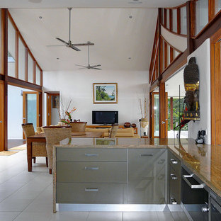 Inspiration for a mid-sized tropical u-shaped eat-in kitchen in Brisbane with flat-panel cabinets, granite benchtops and porcelain floors.