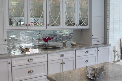 Inspiration for a contemporary kitchen remodel in Los Angeles with raised-panel cabinets, white cabinets and an island