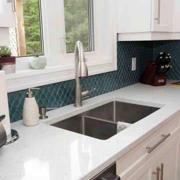 L-Shape white kitchen with Quartz top with blue accents
