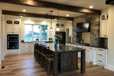Large arts and crafts l-shaped open concept kitchen photo in Toronto with an undermount sink, raised-panel cabinets, quartz countertops, colored appliances and an island