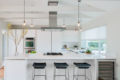 Inspiration for a mid-sized contemporary u-shaped concrete floor open concept kitchen remodel in San Diego with a single-bowl sink, flat-panel cabinets, white cabinets, quartz countertops, white backsplash, stainless steel appliances and no island