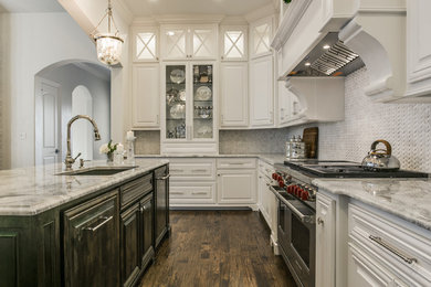 Large transitional u-shaped medium tone wood floor open concept kitchen photo in Dallas with an undermount sink, glass-front cabinets, white cabinets, quartzite countertops, white backsplash, stone tile backsplash, stainless steel appliances and an island