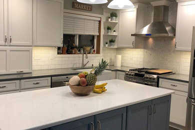 Example of a multicolored floor kitchen design in Portland with white backsplash, subway tile backsplash and an island