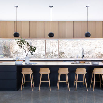 Eat-in kitchen - huge contemporary u-shaped gray floor eat-in kitchen idea in Austin with an island, flat-panel cabinets, light wood cabinets, window backsplash, stainless steel appliances and white countertops