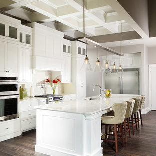 Large traditional open concept kitchen ideas - Open concept kitchen - large traditional u-shaped medium tone wood floor open concept kitchen idea in Other with an undermount sink, shaker cabinets, marble countertops, white backsplash, porcelain backsplash, stainless steel appliances, an island and white cabinets