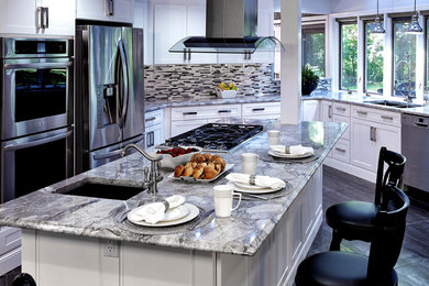 Example of a mid-sized trendy u-shaped porcelain tile eat-in kitchen design in Philadelphia with an undermount sink, shaker cabinets, white cabinets, marble countertops, multicolored backsplash, stainless steel appliances, an island and matchstick tile backsplash