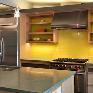Design ideas for a midcentury eat-in kitchen in San Francisco with an undermount sink, recessed-panel cabinets, light wood cabinets, concrete benchtops, yellow splashback, ceramic splashback, stainless steel appliances, ceramic floors and with island.