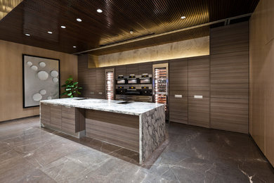 Eat-in kitchen - large contemporary single-wall marble floor eat-in kitchen idea in Orange County with an undermount sink, flat-panel cabinets, medium tone wood cabinets, marble countertops, stainless steel appliances and an island
