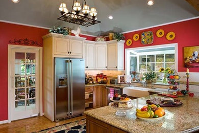 Inspiration for a mid-sized timeless medium tone wood floor and brown floor enclosed kitchen remodel in Orange County with a farmhouse sink, raised-panel cabinets, white cabinets, granite countertops, multicolored backsplash, ceramic backsplash, stainless steel appliances and no island