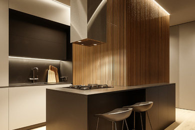 Example of a small trendy galley light wood floor and beige floor kitchen pantry design in Other with a drop-in sink, black cabinets, solid surface countertops, black backsplash, black appliances and an island