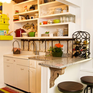 Small shabby-chic style galley separate kitchen in Atlanta with an integrated sink, shaker cabinets, white cabinets, granite benchtops, white splashback, metal splashback, stainless steel appliances and painted wood floors.