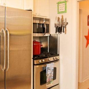 Inspiration for a small shabby-chic style galley separate kitchen in Atlanta with an integrated sink, shaker cabinets, white cabinets, granite benchtops, white splashback, metal splashback, stainless steel appliances and painted wood floors.