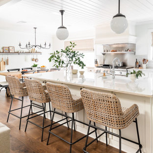 Esempio di una cucina chic di medie dimensioni con ante bianche, top in quarzite, paraspruzzi bianco, paraspruzzi con piastrelle in terracotta, elettrodomestici in acciaio inossidabile, pavimento in legno massello medio, pavimento marrone e top bianco