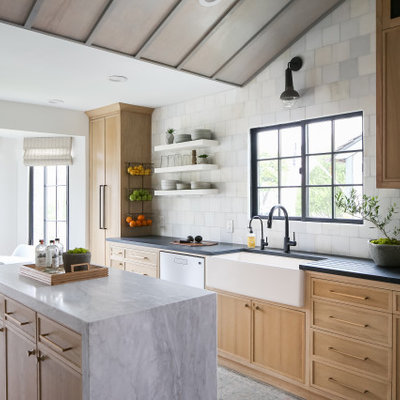 Inspiration for a coastal ceramic tile and gray floor eat-in kitchen remodel in Orange County with a farmhouse sink, light wood cabinets, marble countertops, stainless steel appliances, marble backsplash and an island