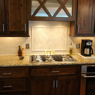 Mid-sized traditional open concept kitchen ideas - Example of a mid-sized classic galley bamboo floor and brown floor open concept kitchen design in Atlanta with an undermount sink, recessed-panel cabinets, dark wood cabinets, granite countertops, white backsplash, ceramic backsplash, stainless steel appliances and two islands