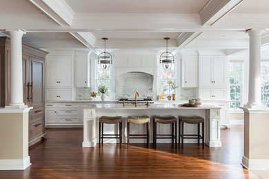 Large elegant l-shaped dark wood floor open concept kitchen photo in Minneapolis with a single-bowl sink, recessed-panel cabinets, white cabinets, quartzite countertops, white backsplash, stone tile backsplash, paneled appliances and an island