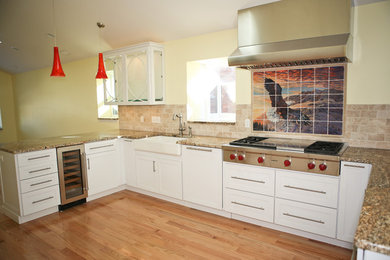 Example of a transitional u-shaped eat-in kitchen design in St Louis with a farmhouse sink, recessed-panel cabinets, white cabinets, granite countertops, beige backsplash and stainless steel appliances