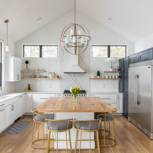Large transitional kitchen inspiration - Inspiration for a large transitional u-shaped medium tone wood floor and brown floor kitchen remodel in Other with an undermount sink, recessed-panel cabinets, white cabinets, quartz countertops, white backsplash, stainless steel appliances, an island and white countertops