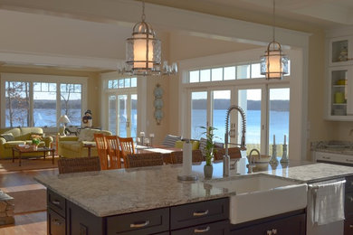 Large beach style single-wall light wood floor eat-in kitchen photo in Other with a farmhouse sink, shaker cabinets, white cabinets, granite countertops, blue backsplash, glass tile backsplash, stainless steel appliances and an island