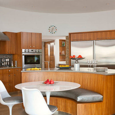 Eat-in kitchen - mid-sized 1950s u-shaped concrete floor and gray floor eat-in kitchen idea in Dallas with flat-panel cabinets, medium tone wood cabinets, an undermount sink, gray backsplash, stainless steel appliances, an island, concrete countertops and mosaic tile backsplash