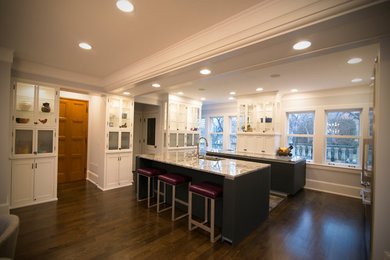 Example of a mid-sized minimalist u-shaped eat-in kitchen design in Minneapolis with flat-panel cabinets and an island