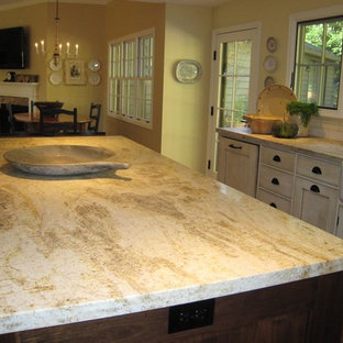 Large traditional eat-in kitchen photos - Eat-in kitchen - large traditional l-shaped dark wood floor and brown floor eat-in kitchen idea in Portland with a farmhouse sink, glass-front cabinets, white cabinets, marble countertops, white backsplash, subway tile backsplash, stainless steel appliances, an island and white countertops