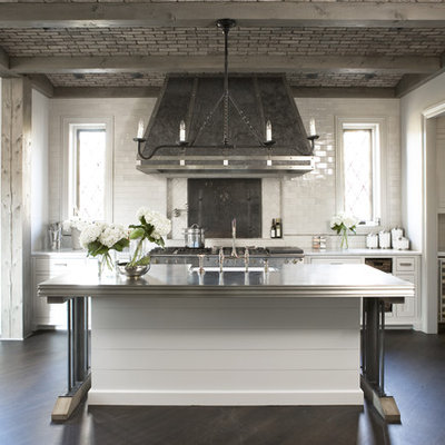 Example of a large transitional galley dark wood floor open concept kitchen design in Other with subway tile backsplash, stainless steel appliances, white cabinets, granite countertops, white backsplash, an island and shaker cabinets