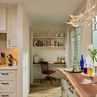 Small transitional l-shaped medium tone wood floor eat-in kitchen photo in Boston with a farmhouse sink, recessed-panel cabinets, dark wood cabinets, marble countertops, beige backsplash, matchstick tile backsplash and stainless steel appliances