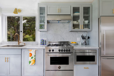 Enclosed kitchen - mid-sized modern galley medium tone wood floor and brown floor enclosed kitchen idea in San Francisco with an undermount sink, shaker cabinets, gray cabinets, marble countertops, white backsplash, marble backsplash, stainless steel appliances and no island
