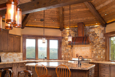Inspiration for a large rustic u-shaped travertine floor and beige floor eat-in kitchen remodel in Denver with an island, an undermount sink, granite countertops, multicolored backsplash, stone tile backsplash, stainless steel appliances, shaker cabinets and dark wood cabinets