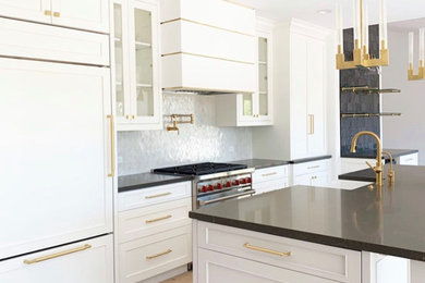 Large trendy l-shaped vinyl floor and beige floor eat-in kitchen photo in Miami with a farmhouse sink, shaker cabinets, white cabinets, quartzite countertops, white backsplash, marble backsplash, stainless steel appliances, an island and gray countertops