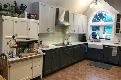 Open concept kitchen - mid-sized coastal u-shaped light wood floor and brown floor open concept kitchen idea in Other with a farmhouse sink, shaker cabinets, gray cabinets, quartz countertops, white backsplash, subway tile backsplash, stainless steel appliances and white countertops