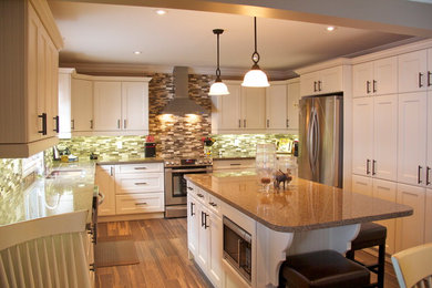 Eat-in kitchen - mid-sized transitional u-shaped dark wood floor eat-in kitchen idea in Toronto with a double-bowl sink, shaker cabinets, white cabinets, granite countertops, multicolored backsplash, matchstick tile backsplash, stainless steel appliances and an island