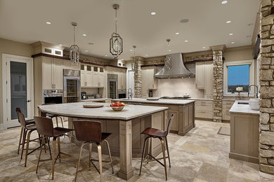 Mid-sized transitional u-shaped limestone floor eat-in kitchen photo in Chicago with an undermount sink, recessed-panel cabinets, beige cabinets, quartzite countertops, white backsplash, stone tile backsplash, stainless steel appliances and two islands