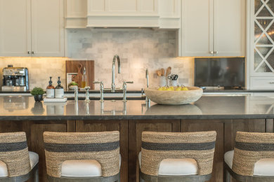 Large beach style l-shaped medium tone wood floor and brown floor open concept kitchen photo in Orlando with an undermount sink, shaker cabinets, white cabinets, granite countertops, white backsplash, subway tile backsplash, stainless steel appliances, an island and black countertops