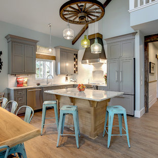Mid-sized coastal eat-in kitchen remodeling - Eat-in kitchen - mid-sized coastal l-shaped vinyl floor eat-in kitchen idea in Grand Rapids with a double-bowl sink, beaded inset cabinets, gray cabinets, granite countertops, white backsplash, subway tile backsplash, stainless steel appliances and an island