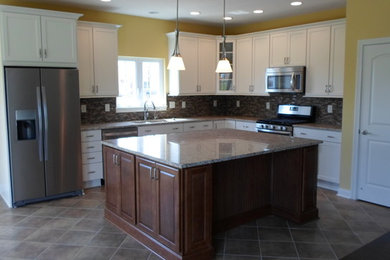 Inspiration for a timeless l-shaped eat-in kitchen remodel in Indianapolis with an undermount sink, granite countertops, stainless steel appliances and an island