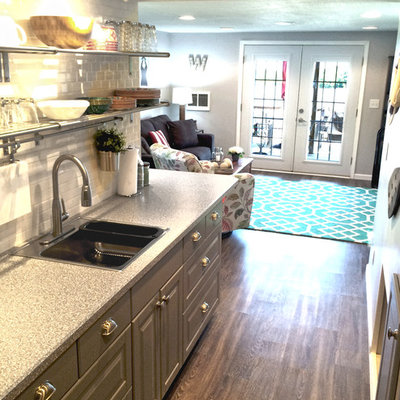 Example of a small trendy galley medium tone wood floor eat-in kitchen design in Other with a single-bowl sink, recessed-panel cabinets, gray cabinets, white backsplash, subway tile backsplash, stainless steel appliances and no island