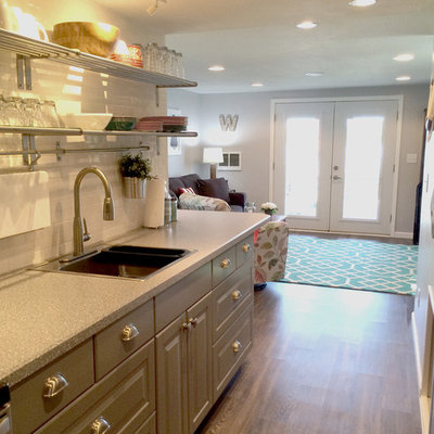 Inspiration for a small contemporary galley medium tone wood floor eat-in kitchen remodel in Other with a single-bowl sink, recessed-panel cabinets, gray cabinets, laminate countertops, white backsplash, subway tile backsplash, stainless steel appliances and no island