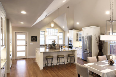 Inspiration for a mid-sized contemporary l-shaped medium tone wood floor and brown floor open concept kitchen remodel in Sacramento with a farmhouse sink, recessed-panel cabinets, white cabinets, granite countertops, stone slab backsplash, stainless steel appliances, an island and green countertops