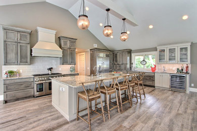 Kitchen - transitional vinyl floor kitchen idea in Atlanta with recessed-panel cabinets, gray cabinets, granite countertops, gray backsplash, porcelain backsplash, stainless steel appliances and an island