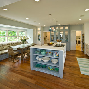 Design ideas for a tropical kitchen pantry in Hawaii with an integrated sink, shaker cabinets, white cabinets, solid surface benchtops, blue splashback, glass tile splashback, panelled appliances and with island.